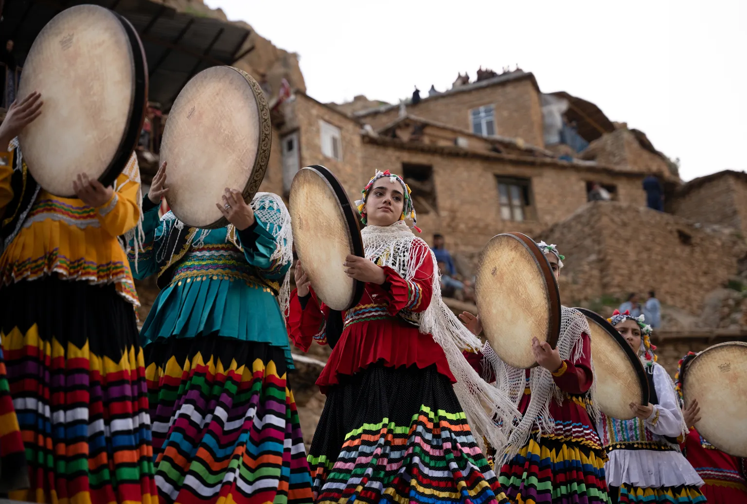 Women playing the daf in the historic stepped village of Palangan, Iran
